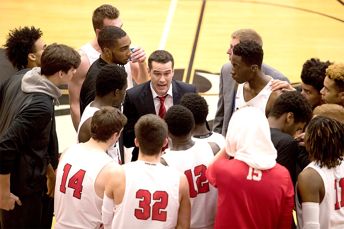 team huddled around coach