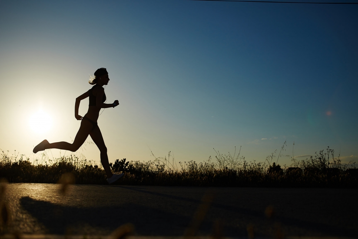 Photo of runner at sunrise.