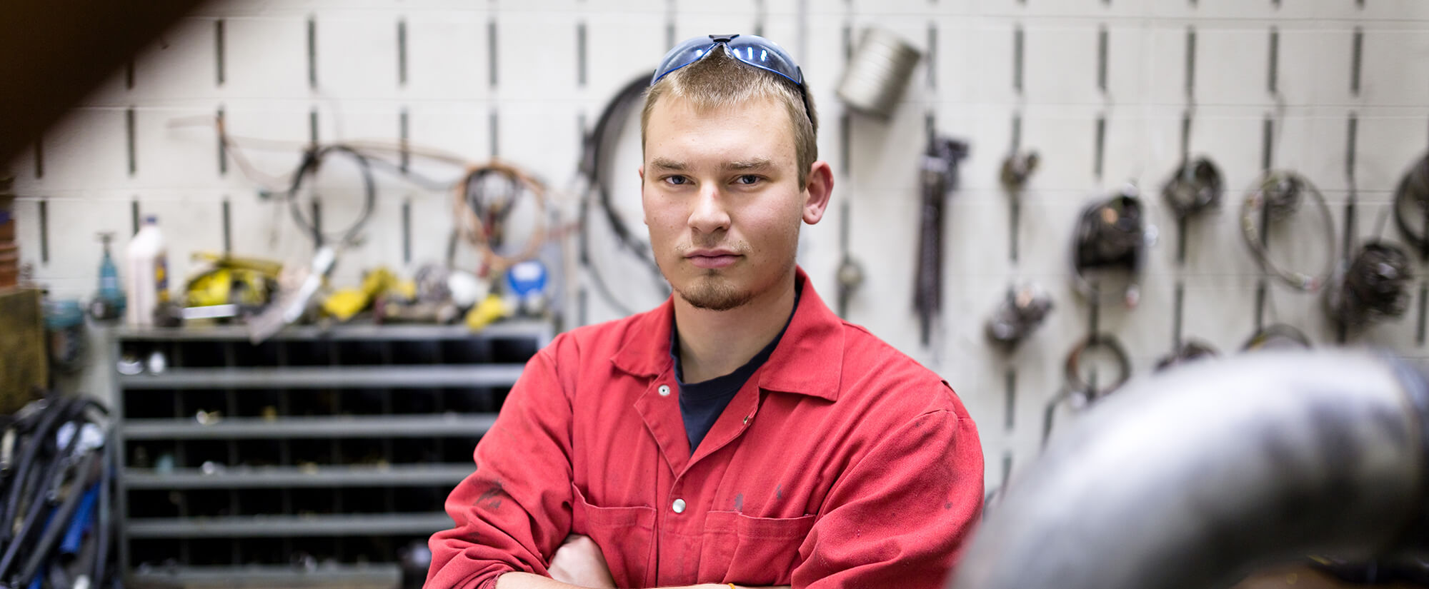 accounting-casper-college Casper College student poses in a workspace with diesel tools.