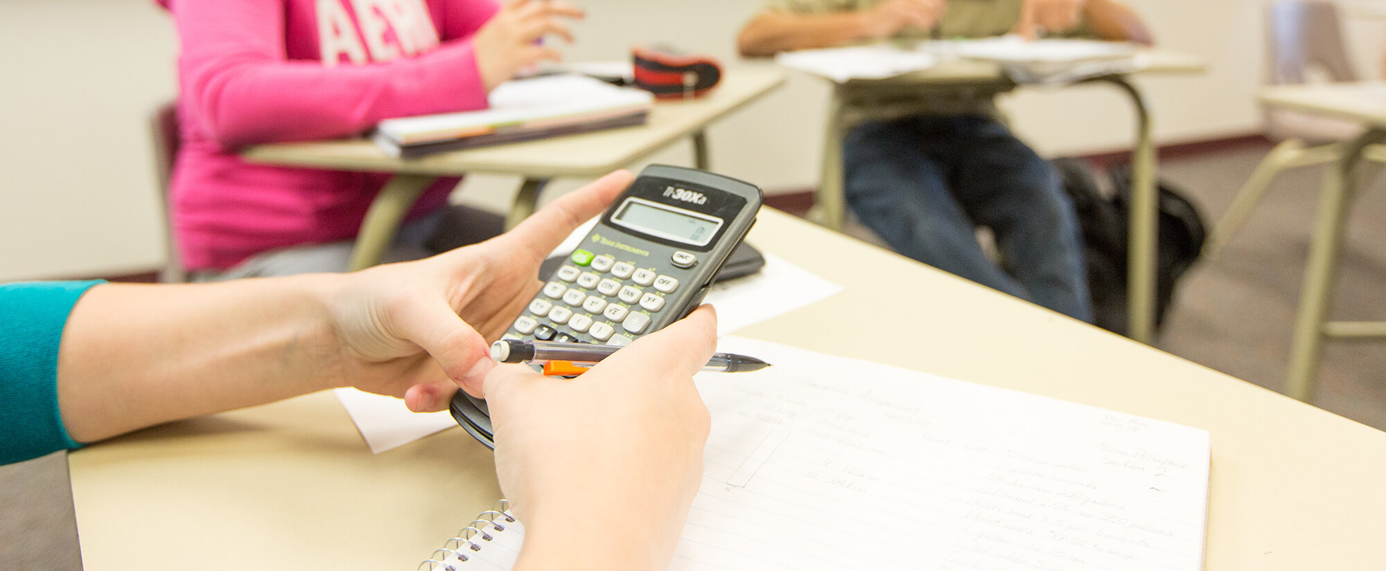 accounting-casper-college Photo of student using a calculator.