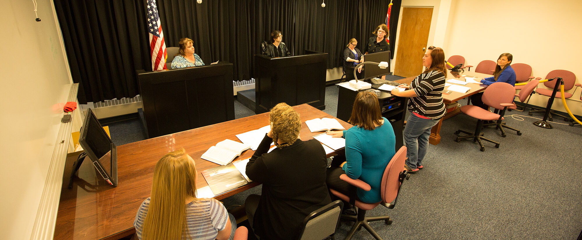 Students act out a courtroom scene as part of the paralegal program.