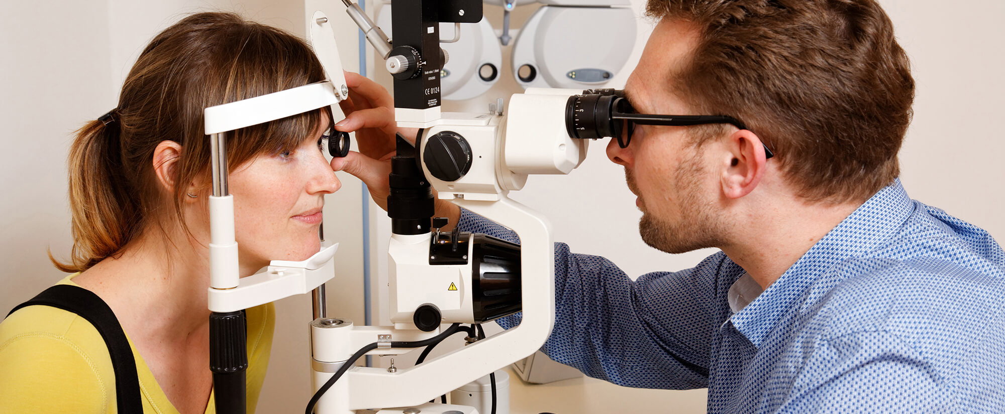 Photo of an optometrist assessing the vision of a patient.