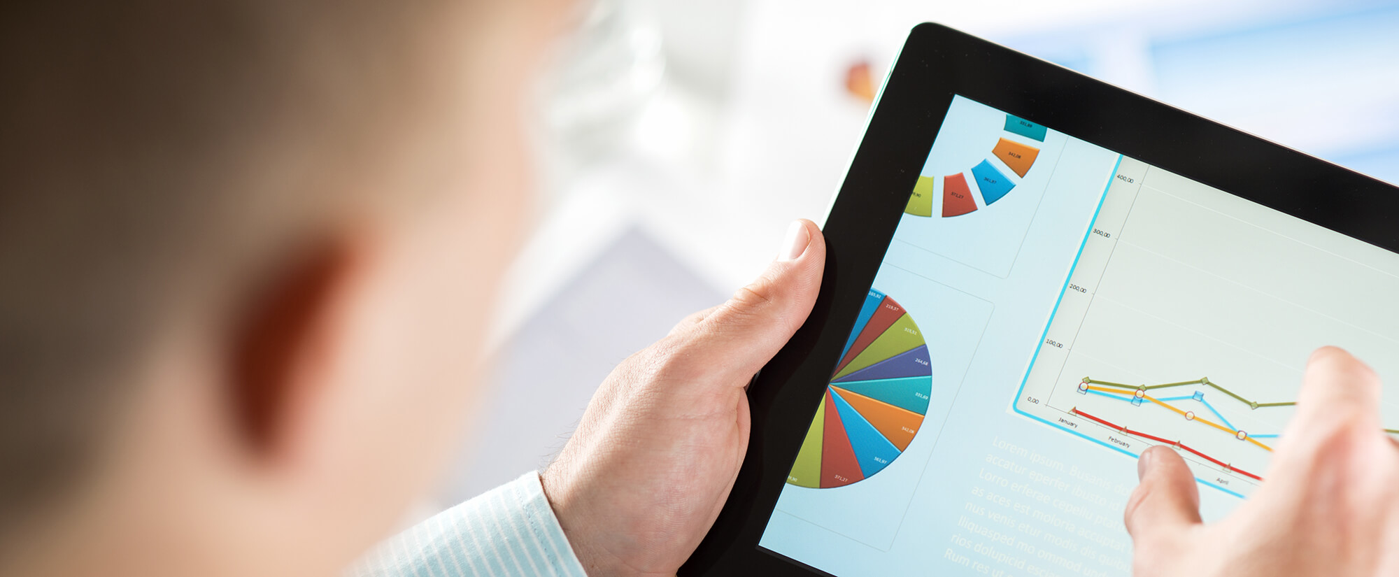 accounting-casper-college Photo of someone using an iPad to look at pie charts and line charts.