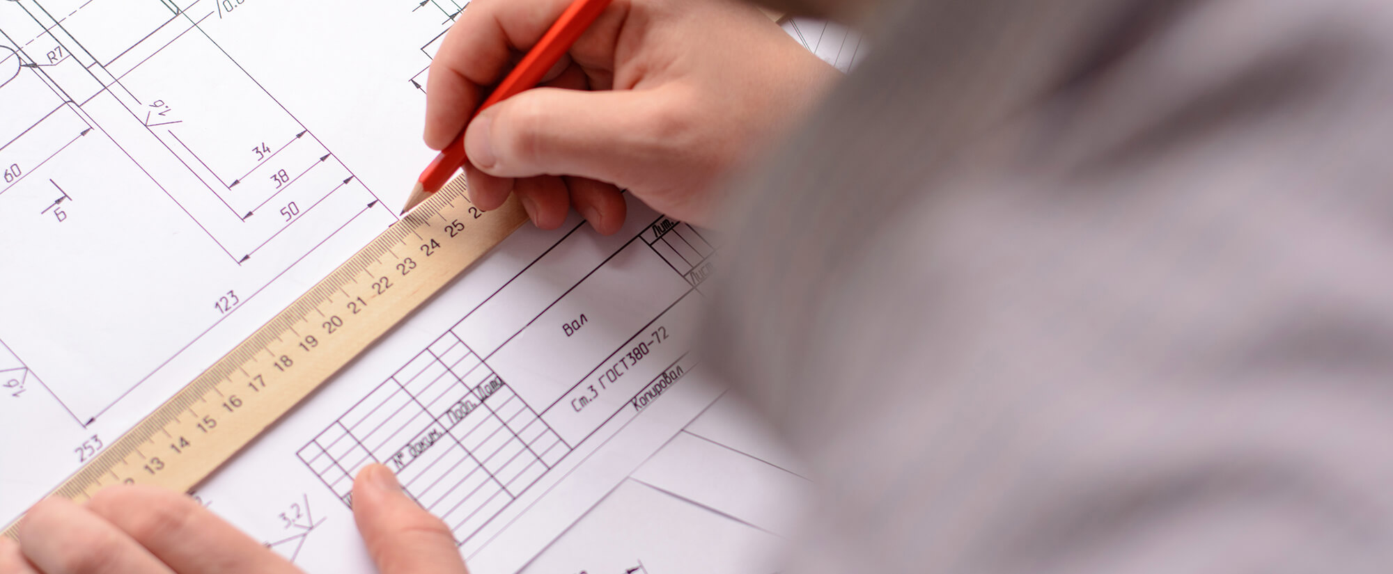 accounting-casper-college Close-up photo of someone drawing building blueprints.