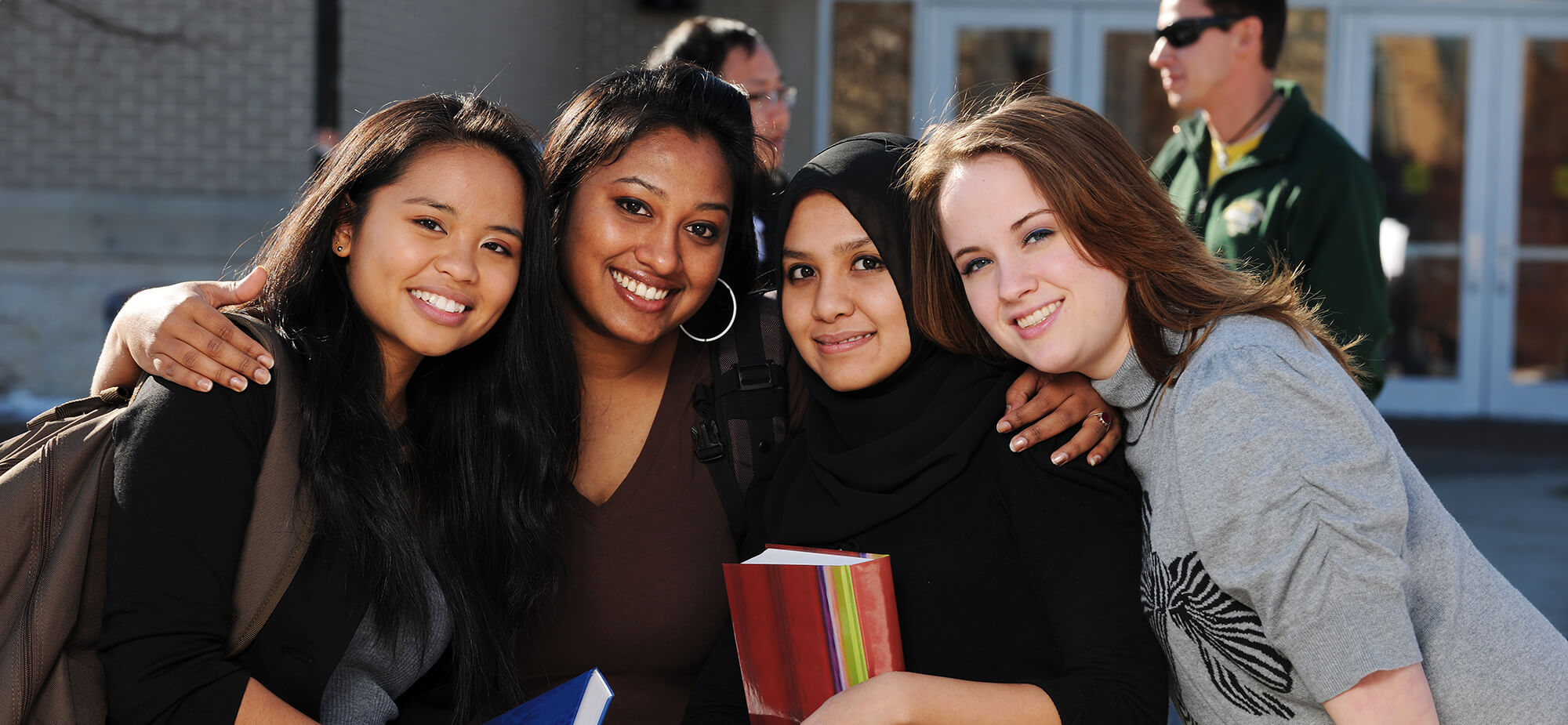 accounting-casper-college Candid photo of four female college students, two men appear in the background.