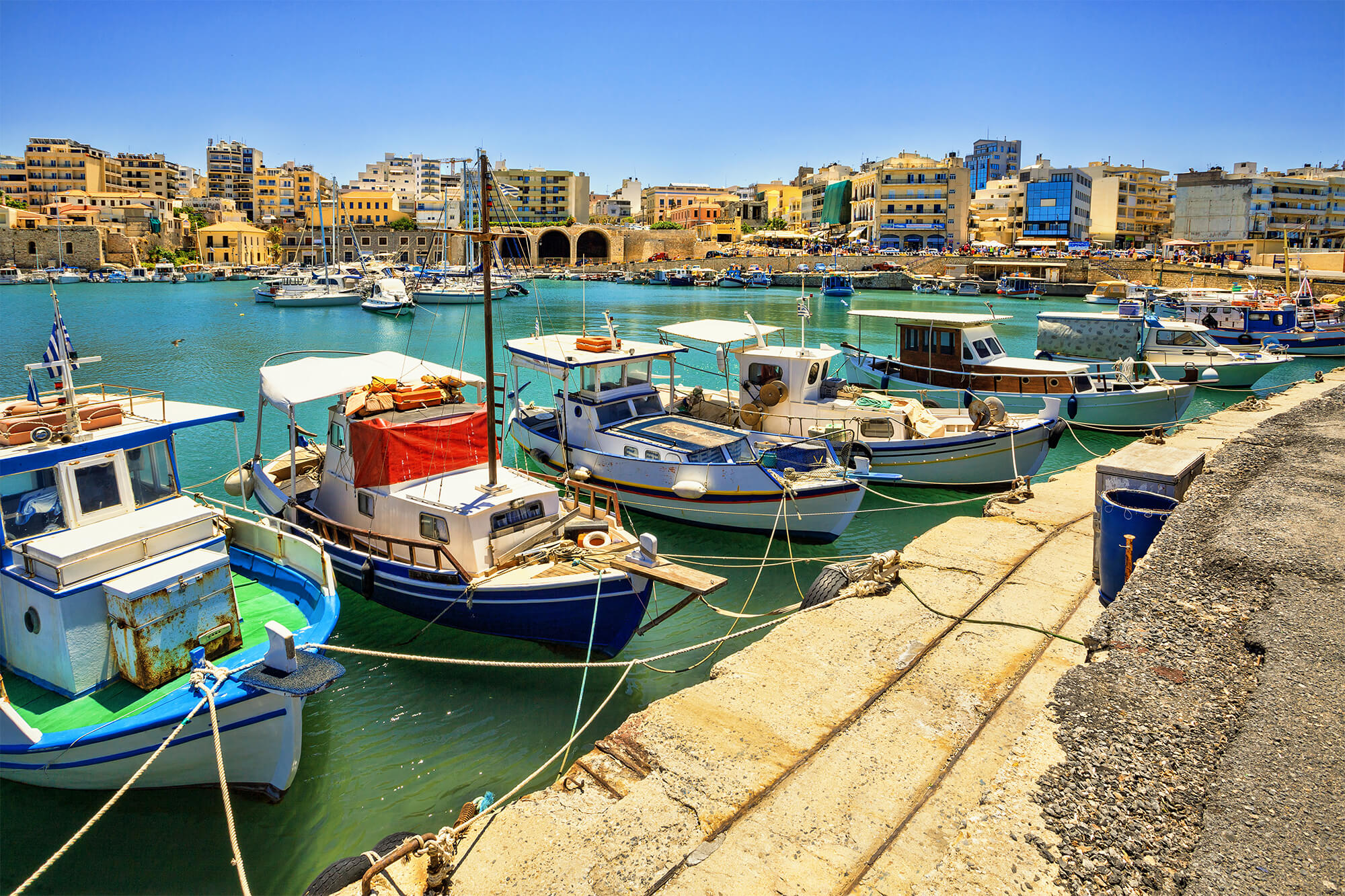 Color photo of boats docked in a port on the Greek island of Crete