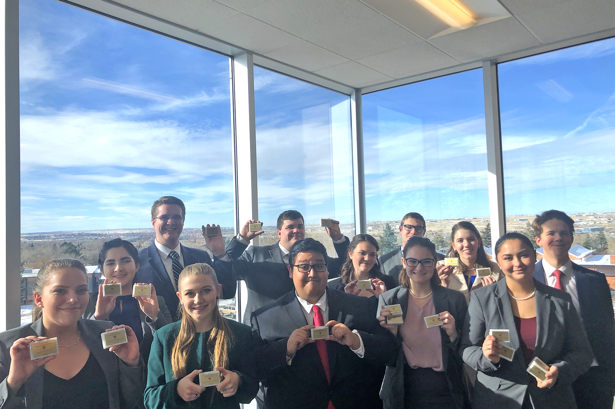 Photo of the Casper College Forensics team holding their awards from the Pioneer Trails Forensics Tournament.