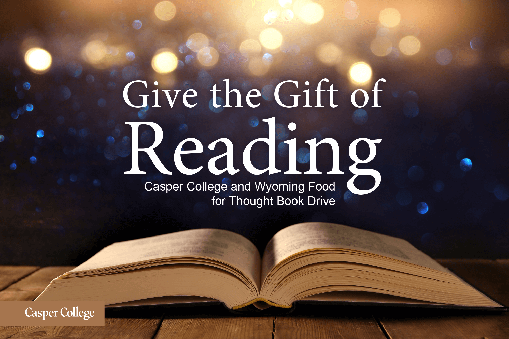 Image of an open book with the words "Give the Gift of Reading Casper College and Wyoming Food for Thought Book Drive."