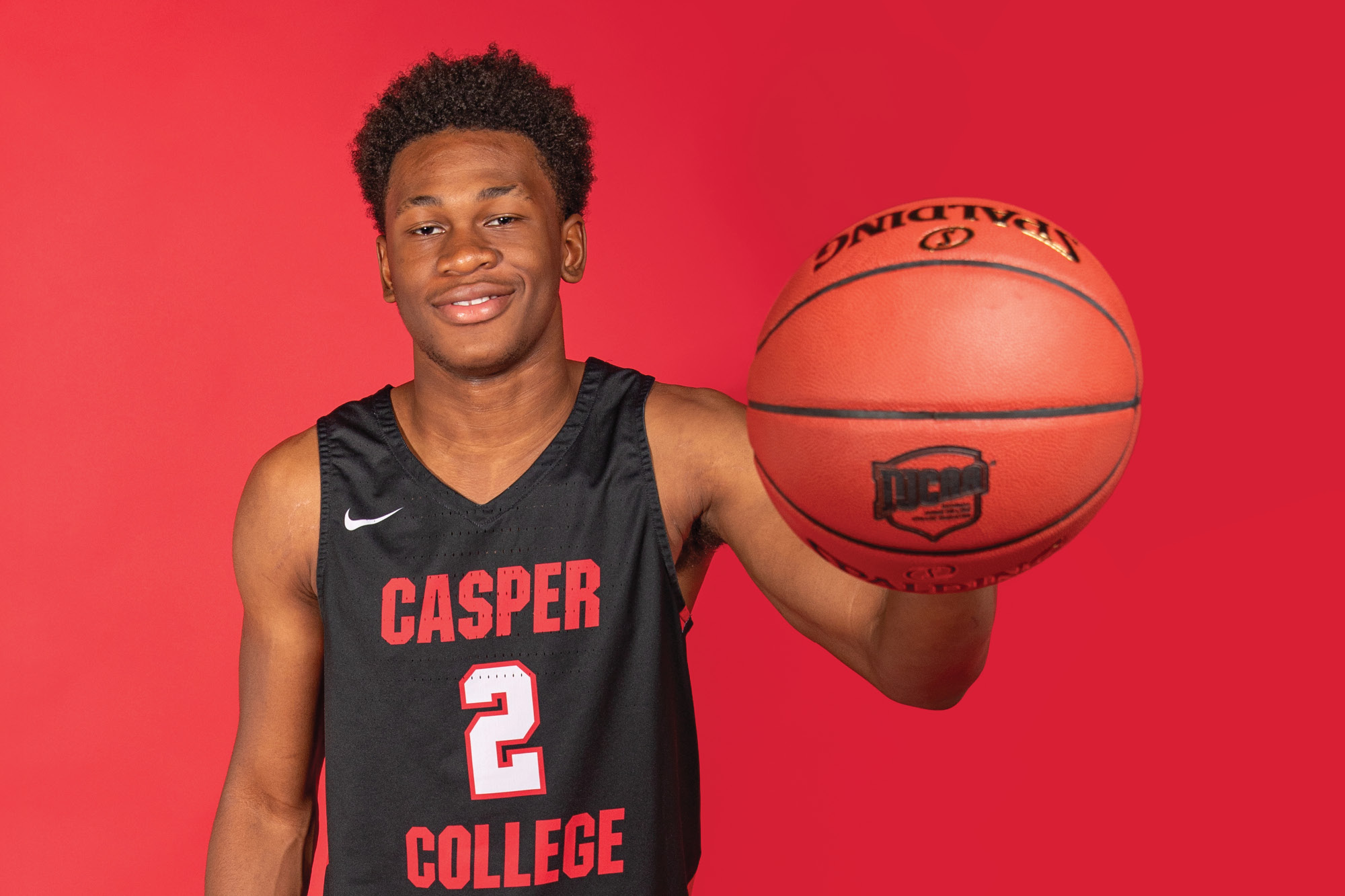 Photo of Casper College basketball player David Walker holding a basketball.