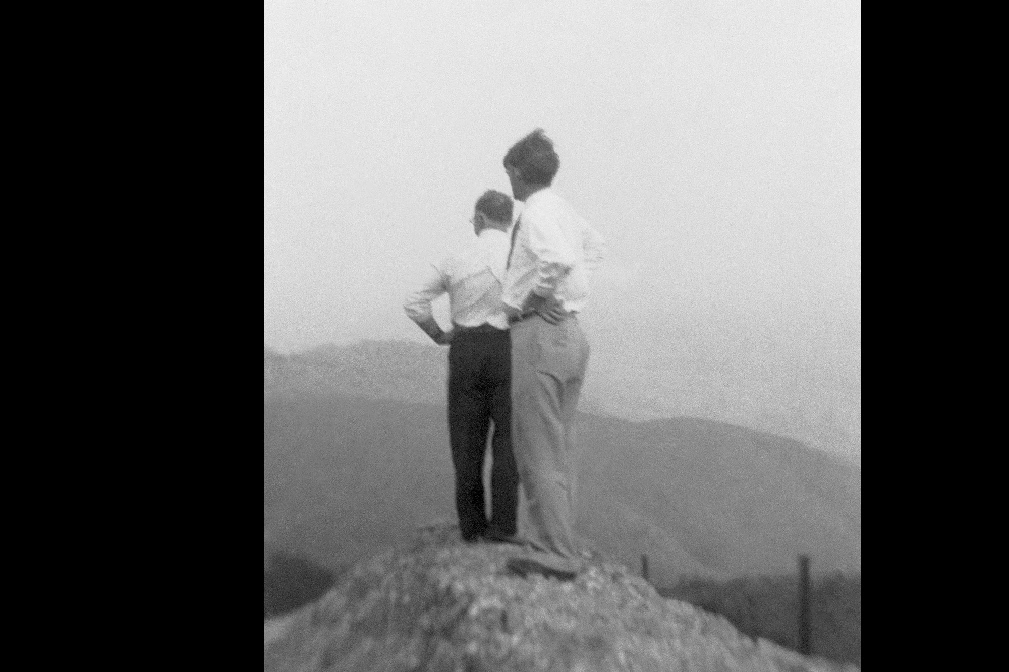 Photograph of two unidentified men looking into the distance.