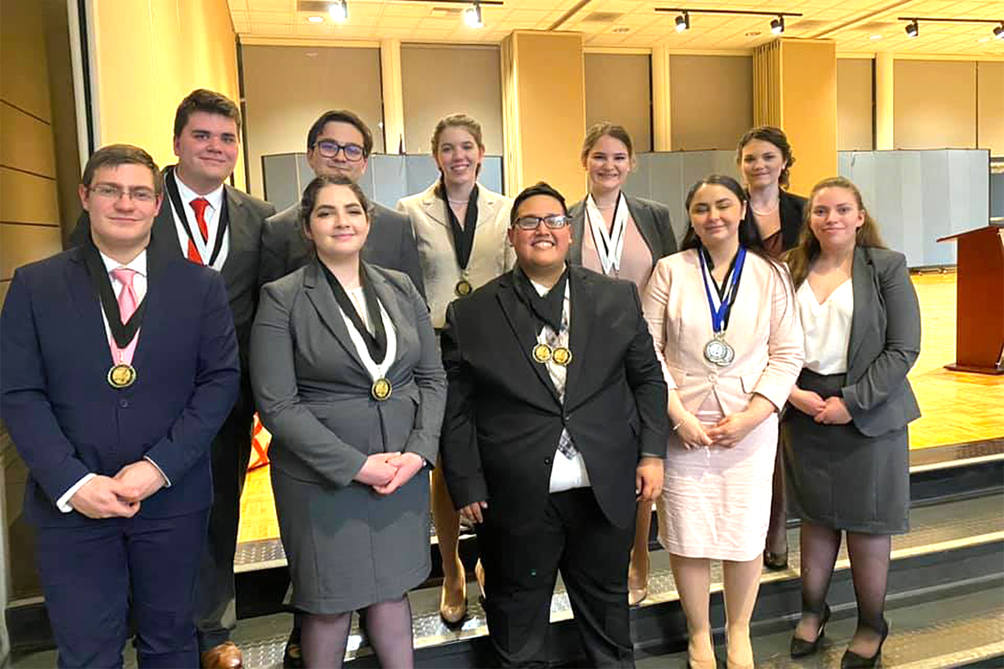 Photo of the Casper College Debate team at the Tabor Venitsky Debate with the medals they won.