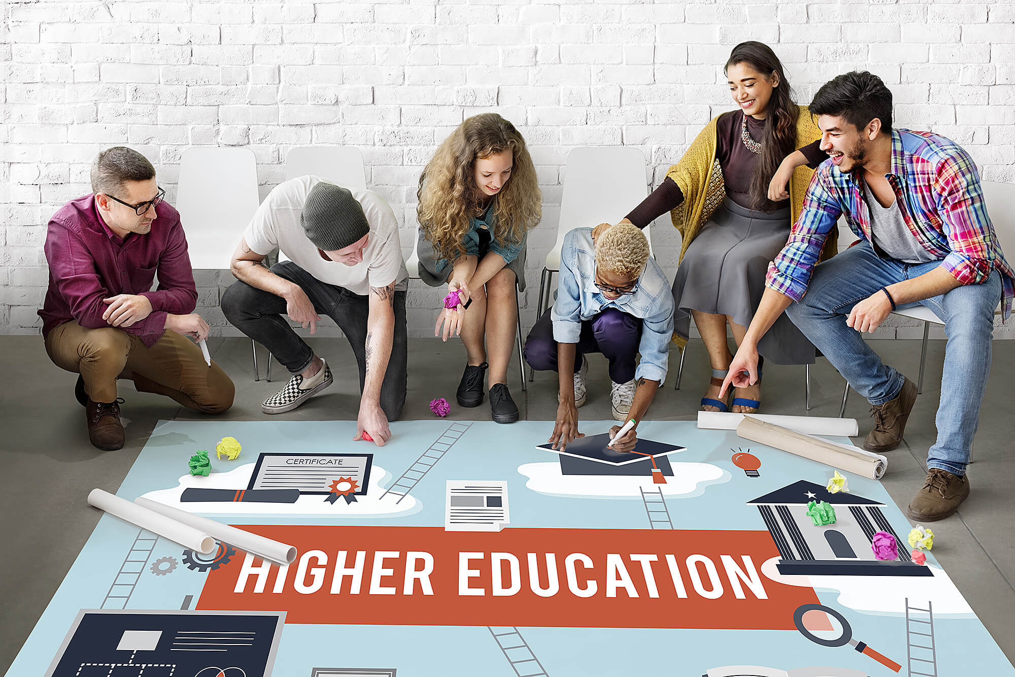 Photo of a group of students looking at a plan for higher education.