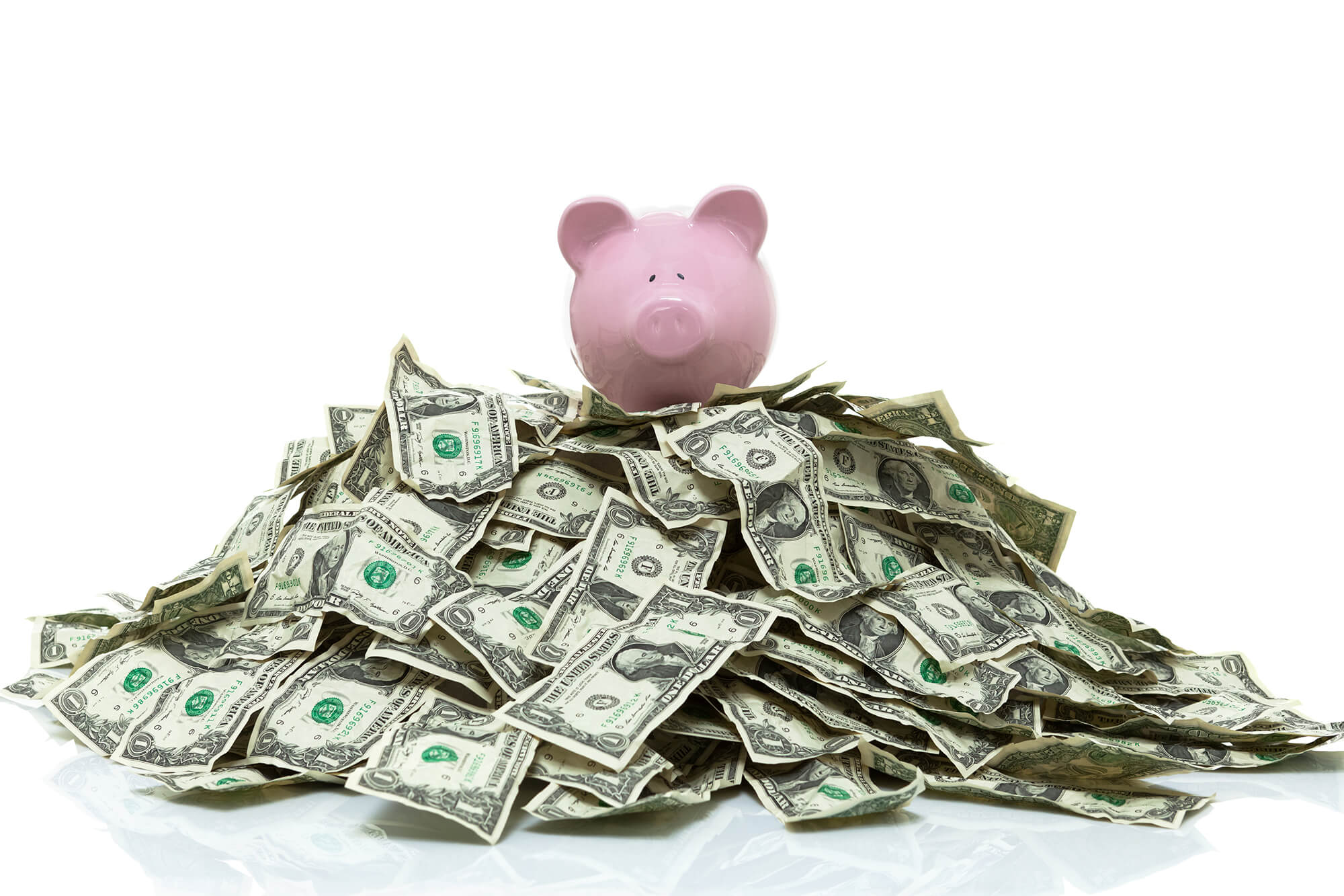 PiggyBankWithDollars(1) Photo of piggy bank with dollar bills surrounding it.