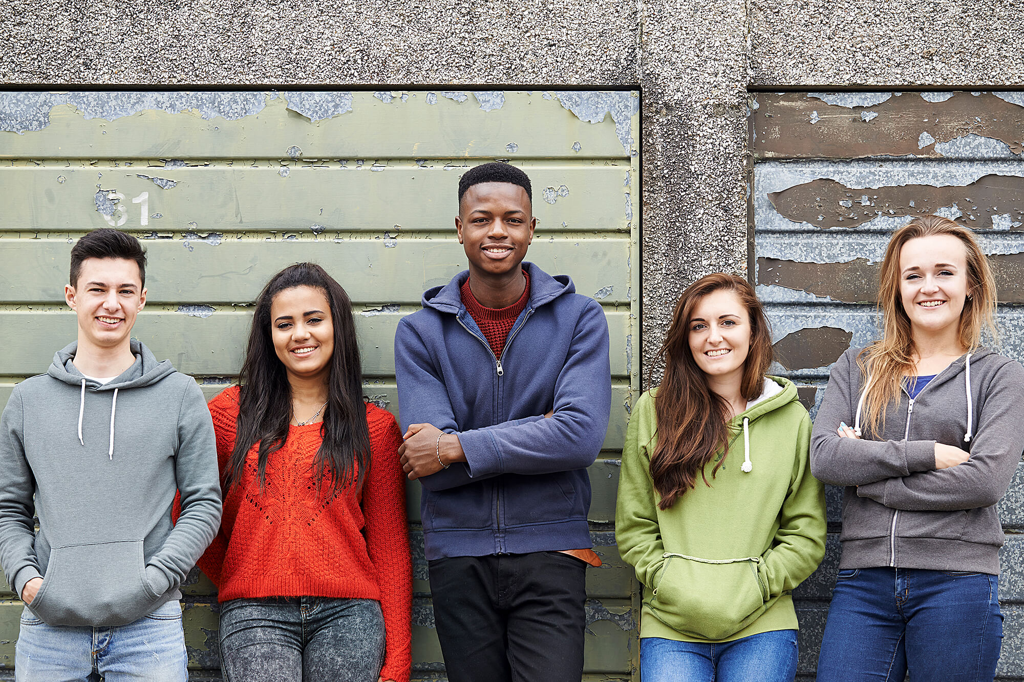 MixedGroupOfStudents2 A photo of a group of late high school or early college students outside a storage unit.