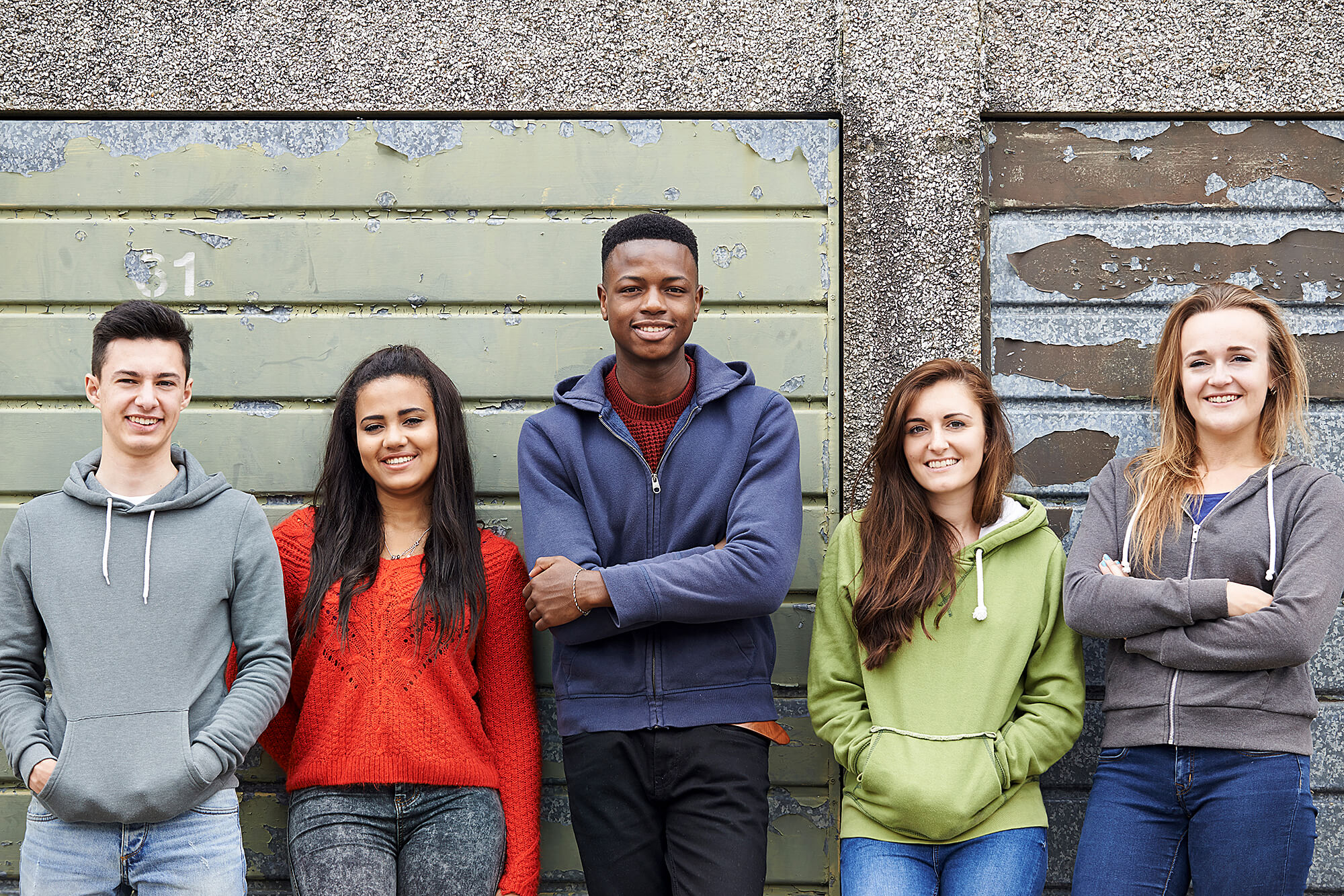 A photo of a group of late high school or early college students outside a storage unit.