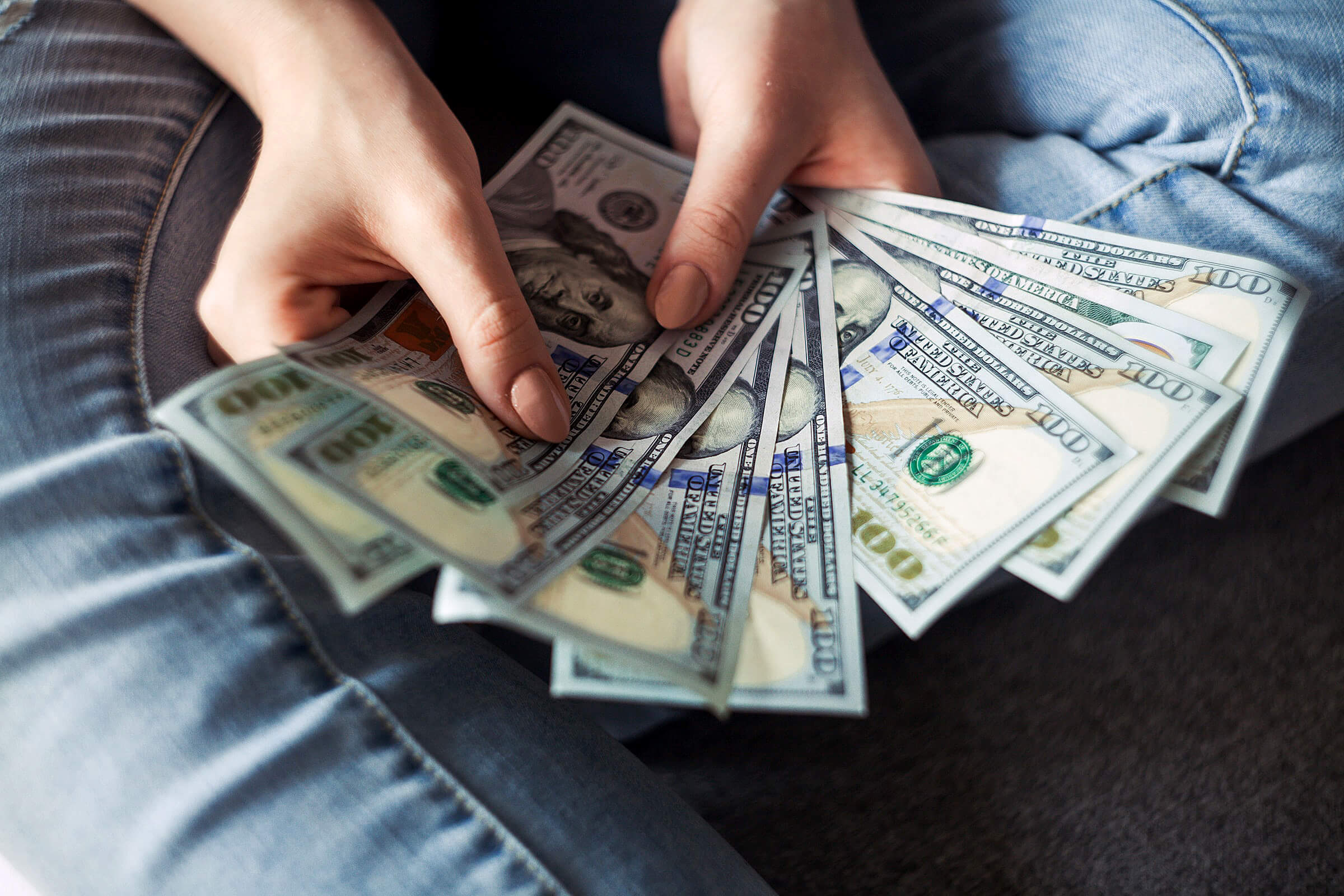 Photo of money in a person's hands.