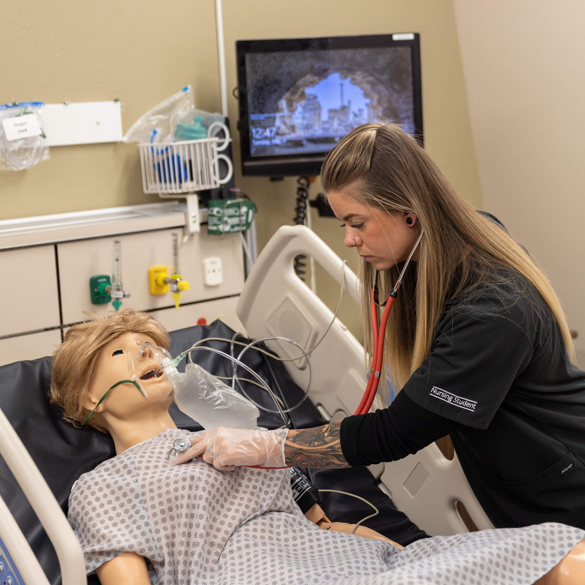 Nursing student with mannequin