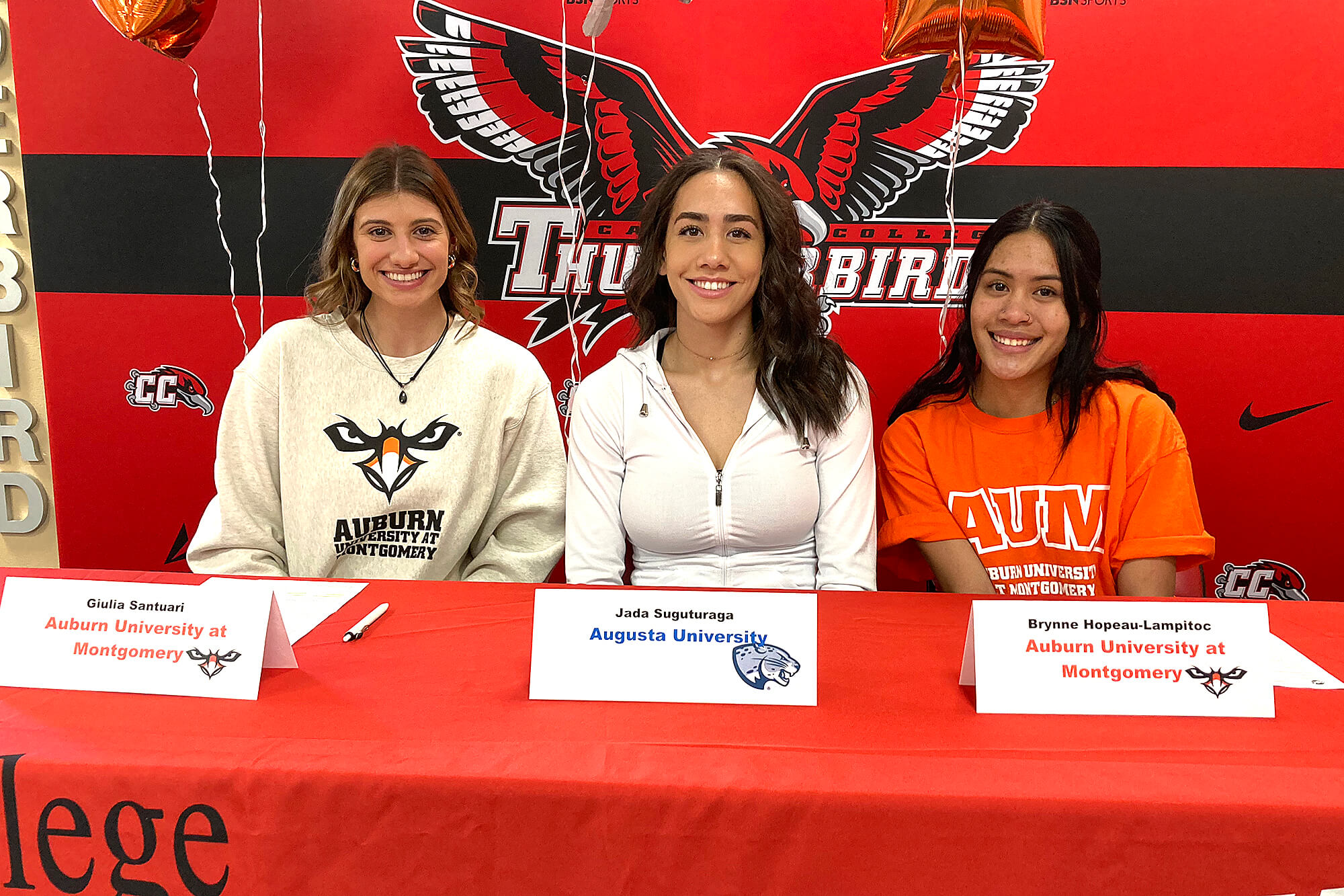 Photo of three volleyball players going to Division II colleges.