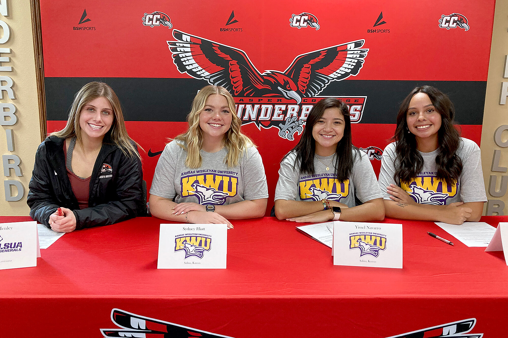 Photo of four Casper College Women's Soccer team players signing their letters of intent.