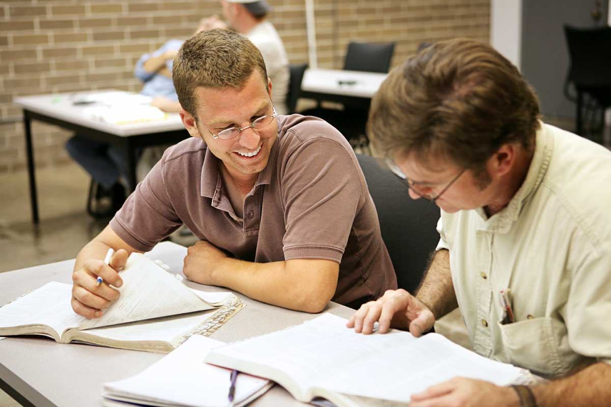 Student sitting with teacher