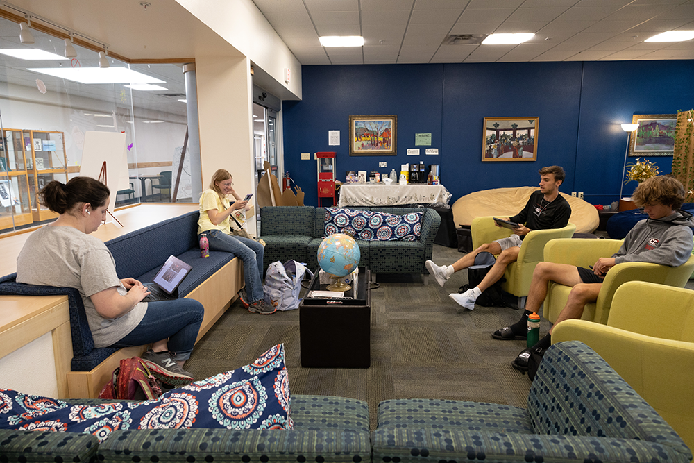 group of college students sitting in the writing center