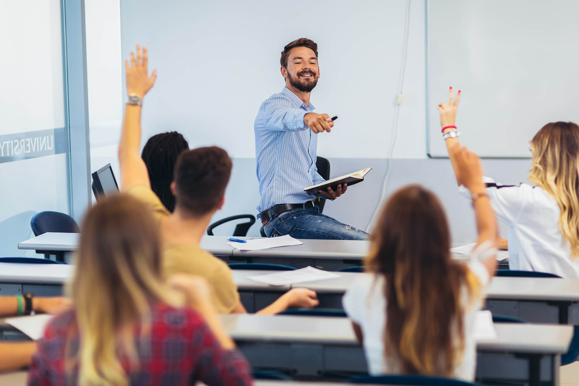 Photo of instructor and students in a classroom.