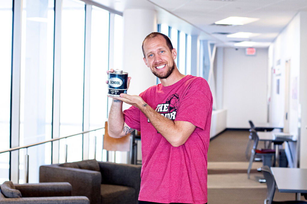 Tom Parks poses with the Oil City News award given to Casper College as the No. 1 School in Natrona County.