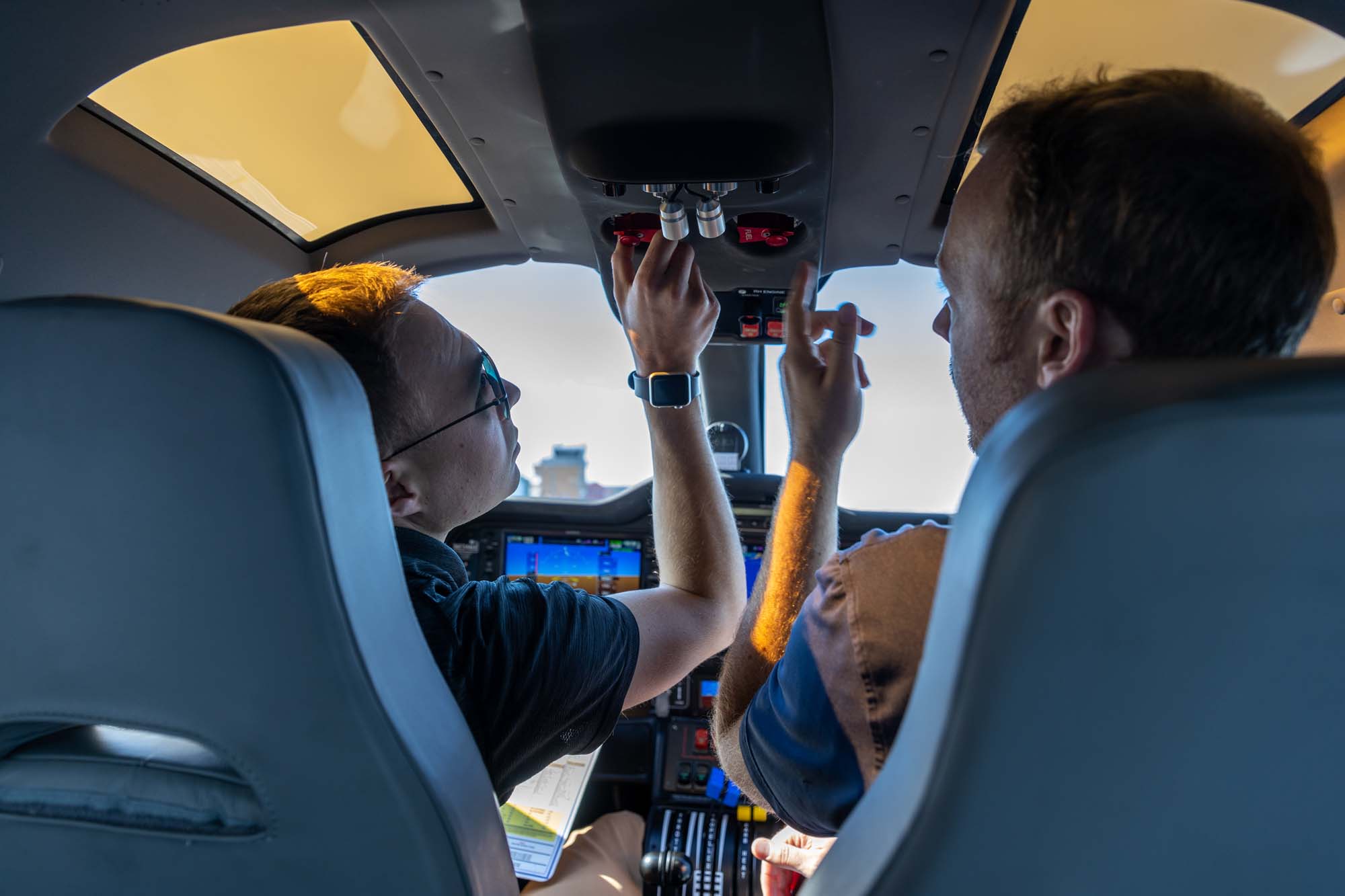 Certified flight instructor Brek Carper checks the oil of a plane at Natrona County International Airport.