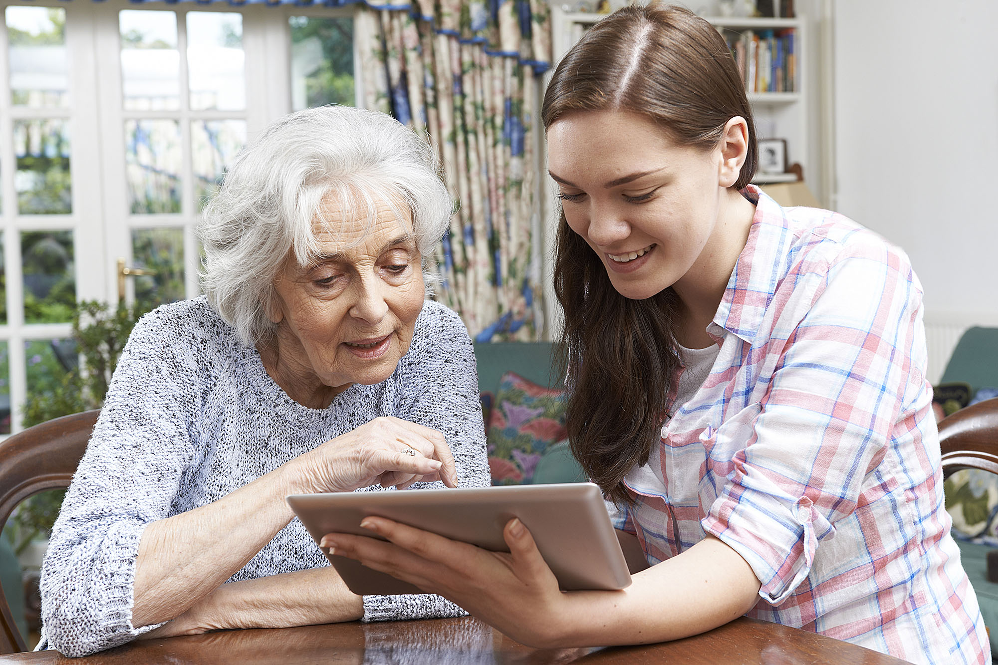 Photo of senior citizen receiving help from a young adult for the OLLI Tech2Connect press release.