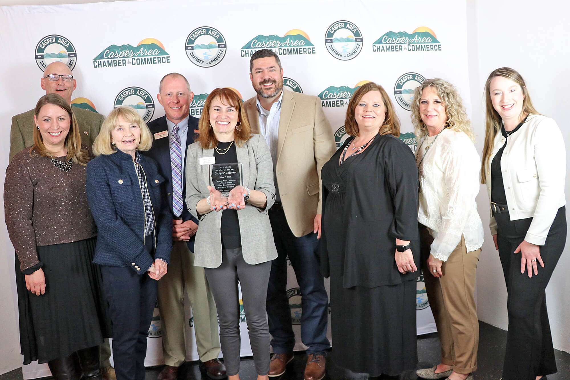 ChamberOfCommerceAwardImage–0525 Photo of Casper College employees with the award the school won from the Casper Area Chamber of Commerce in recognition of the college being named the Chamber's Member of the Year.
