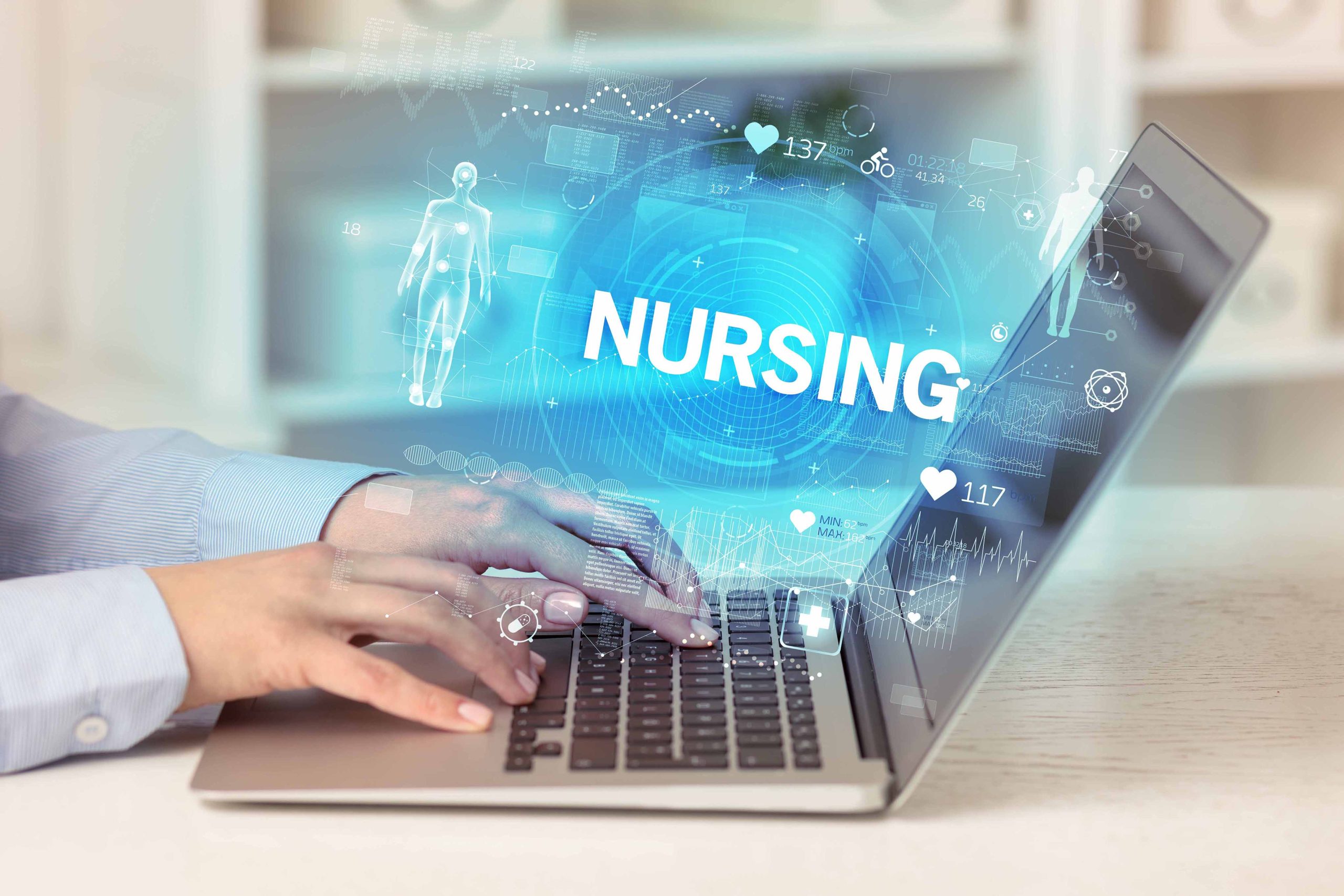 A close-up of hands typing on a laptop with a digital "NURSING" graphic overlay, representing the blend of technology and healthcare education to illustrate the nursing hybrid degree option at Casper College.