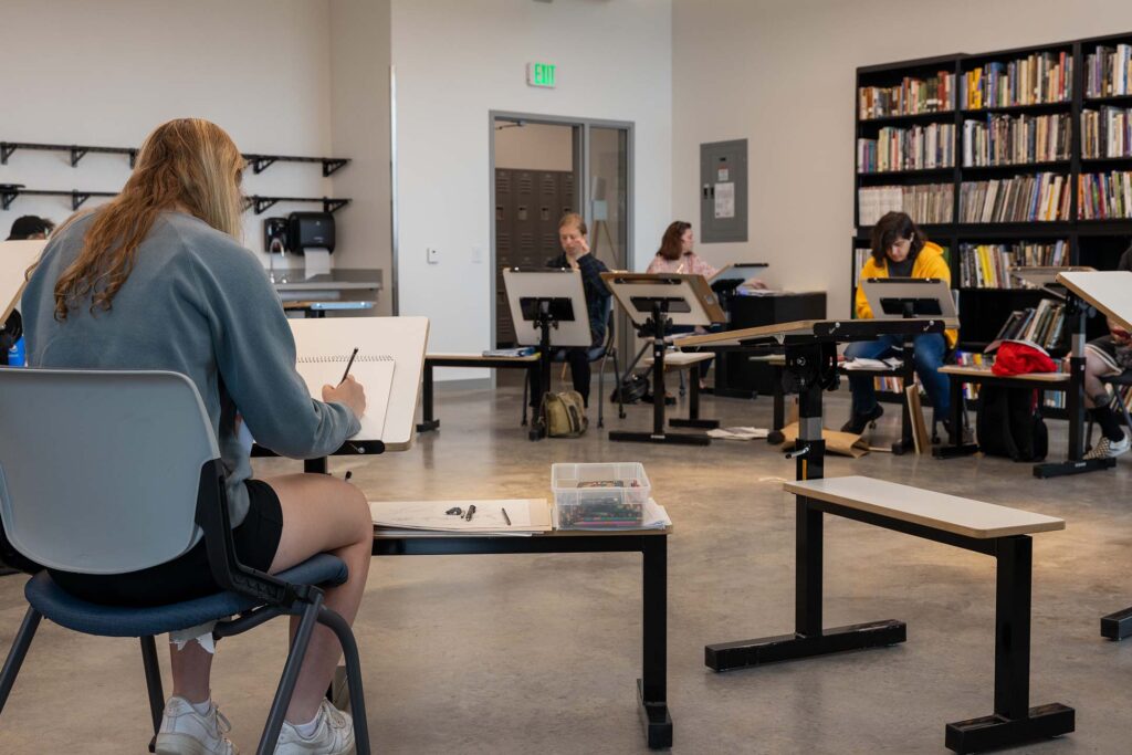 People sitting in an art class working their sketches