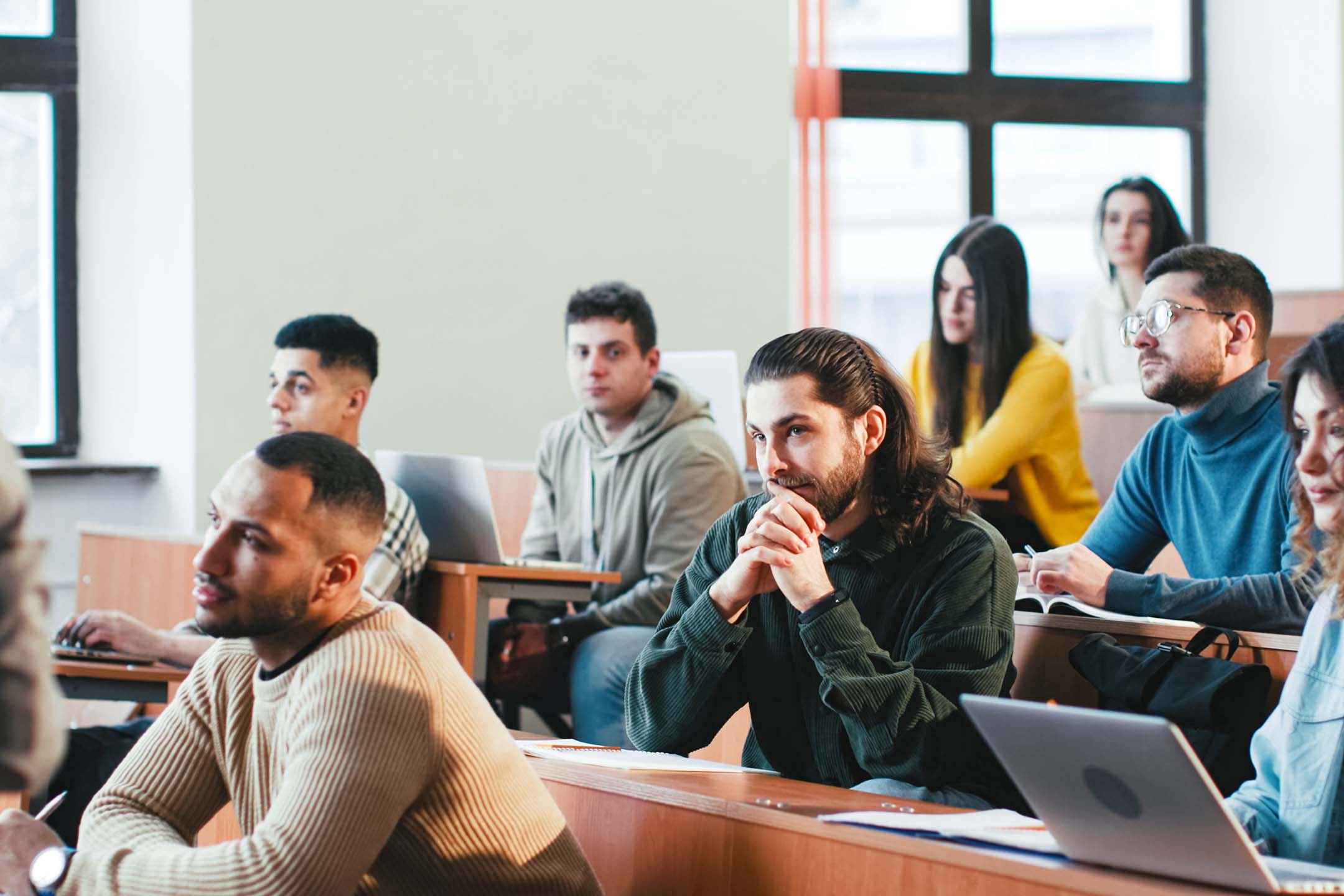College students listening during a classroom mathematics lecture.