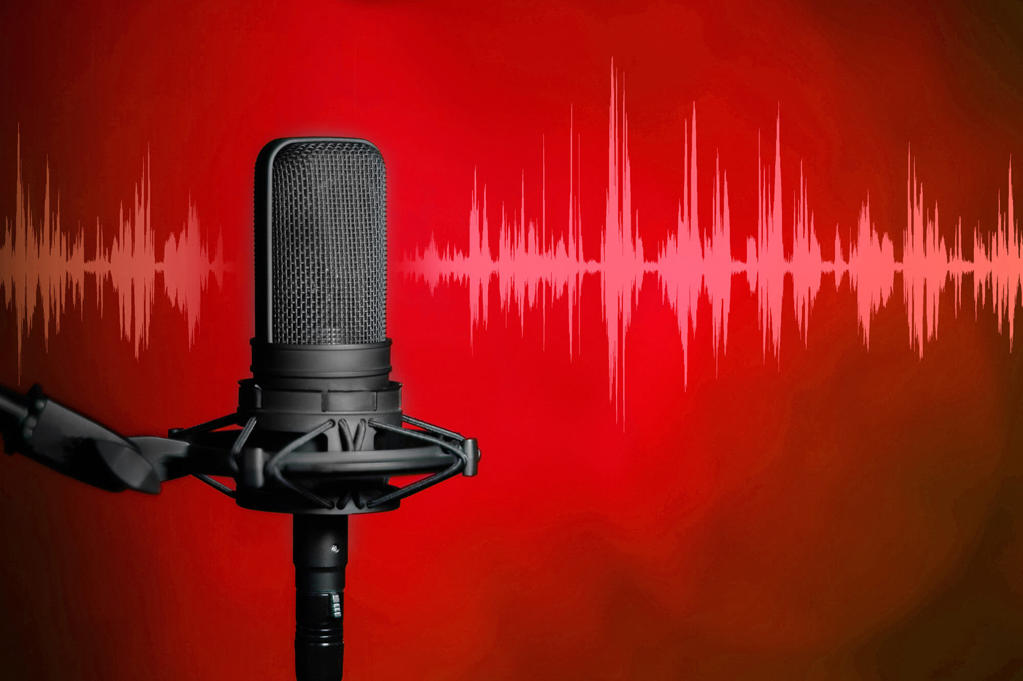 Professional microphone against a red background with a white digital audio waveform.