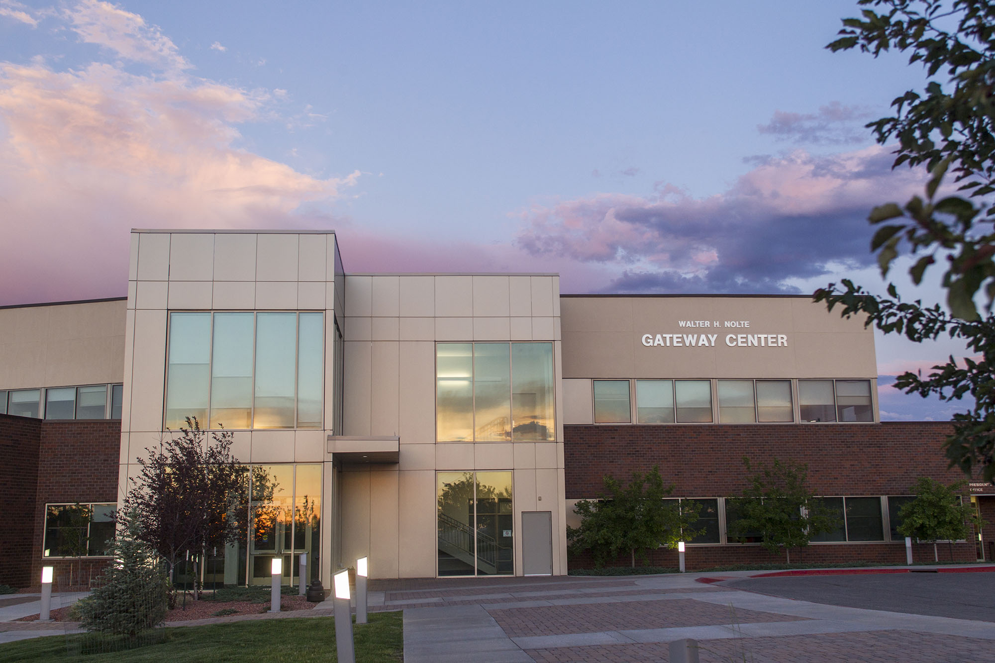 Exterior view of the Walter H. Nolte Gateway Center at Casper College during a pink and purple sunset.