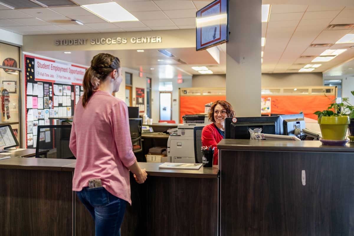 student success center. two people talking at a desk