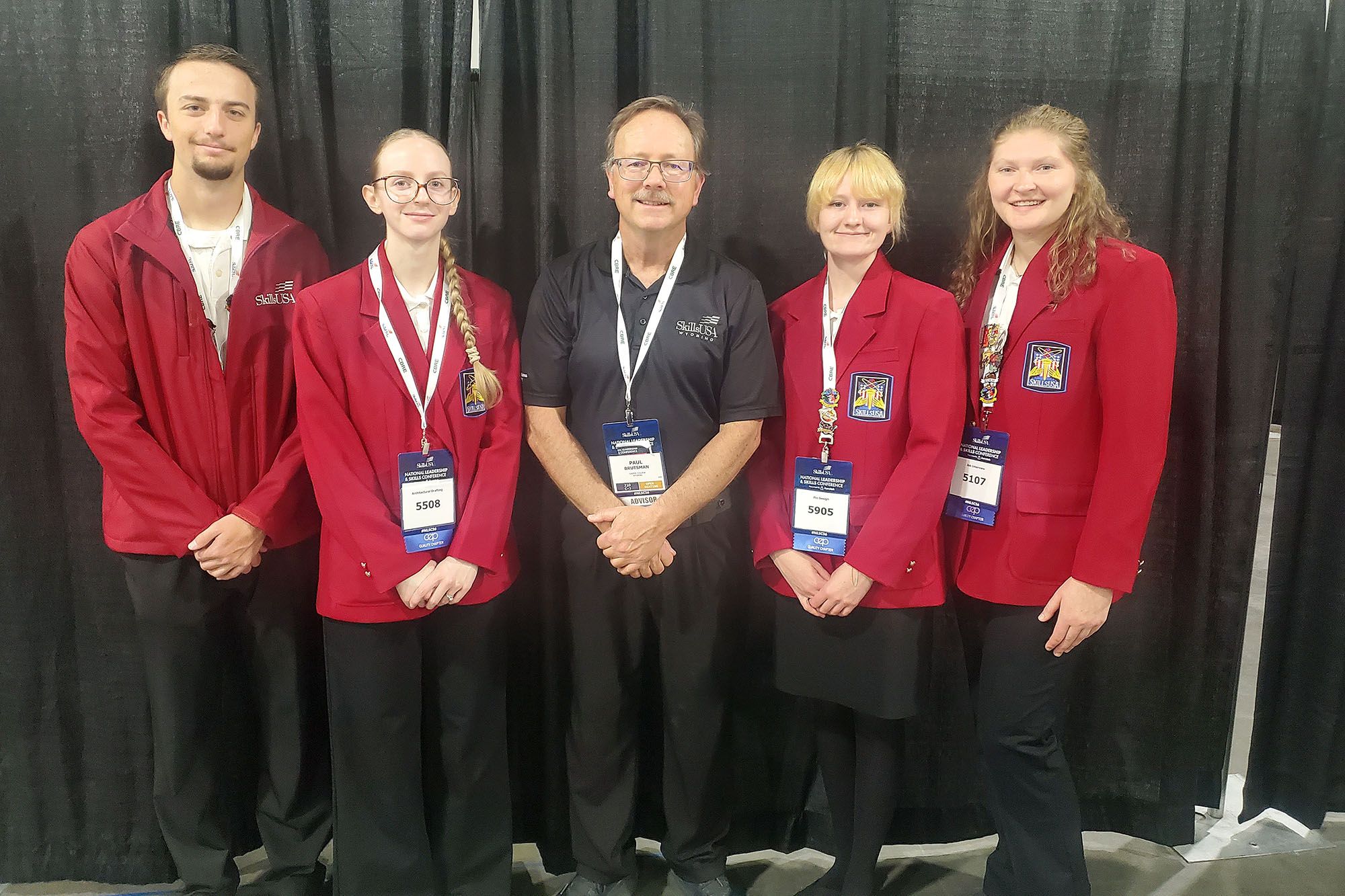 Casper College students Howard McNiven, Kimberly Bjornstad, Fionna Kerkes, and Katelyn Moeller stand with instructor Paul Brutsman in official SkillsUSA attire.