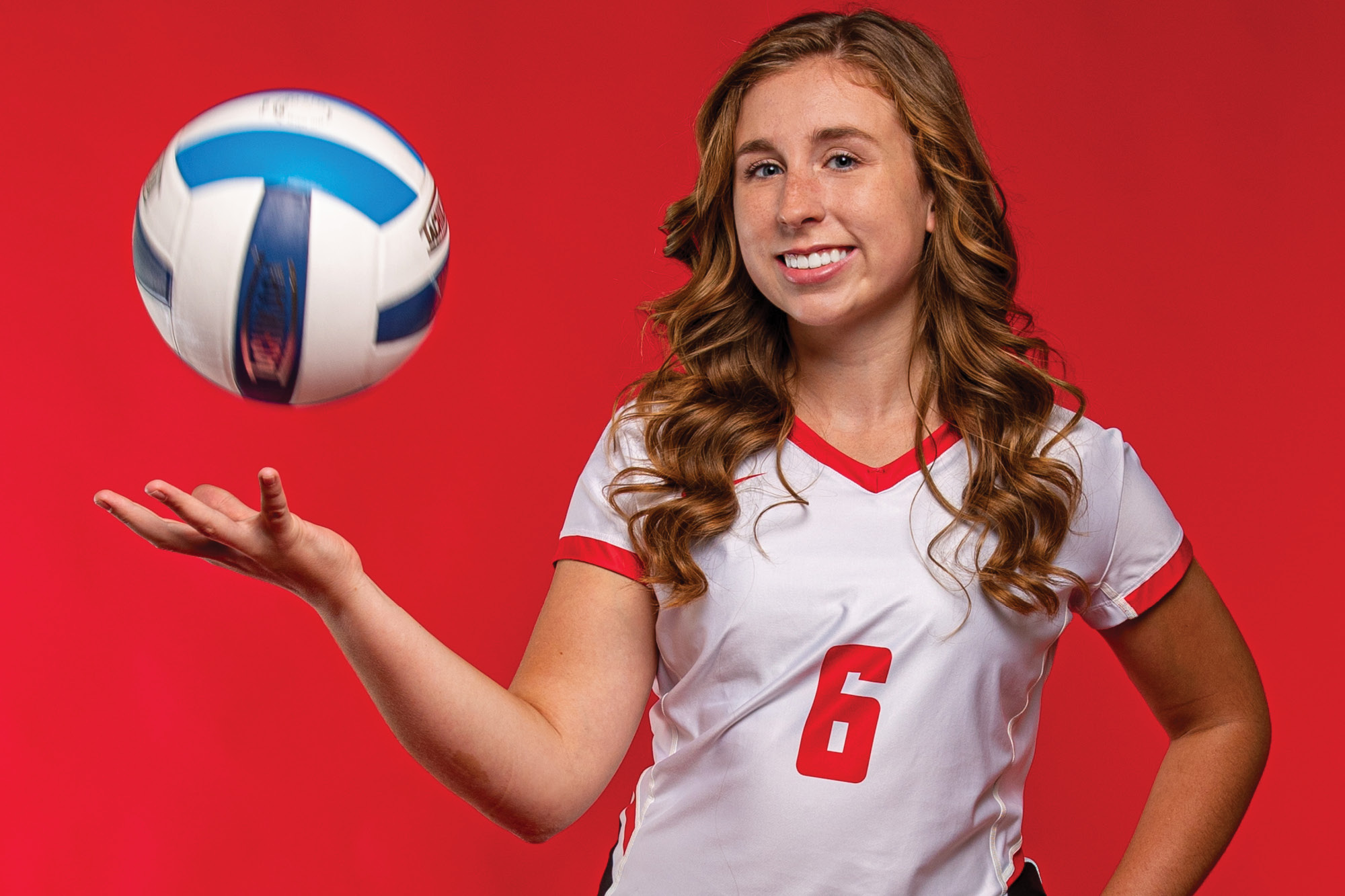 Photo of Casper College volleyball player Kylie Watson tossing up a volleyball