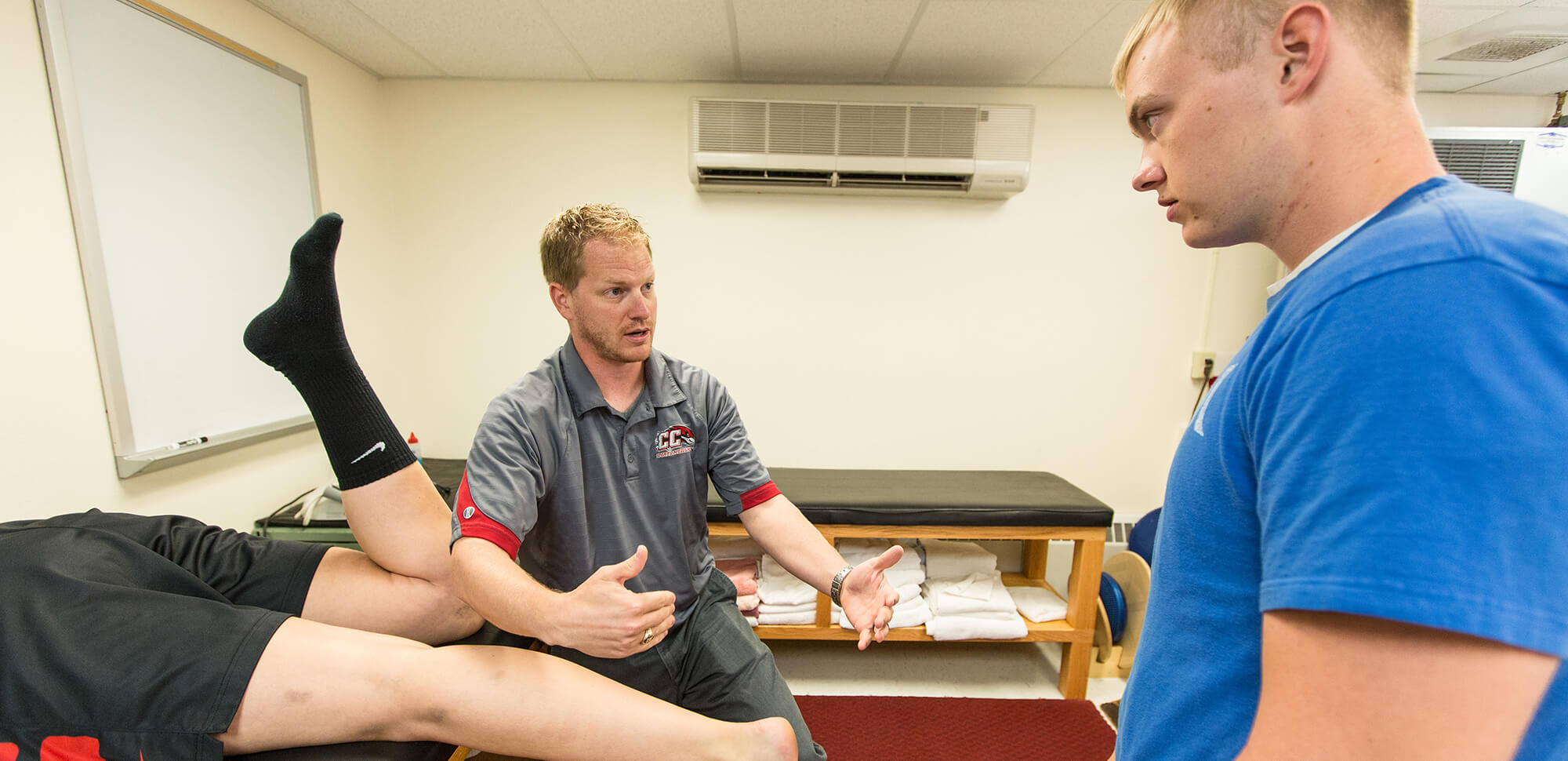 accounting-casper-college an instructor demonstrates leg mobility with a student model