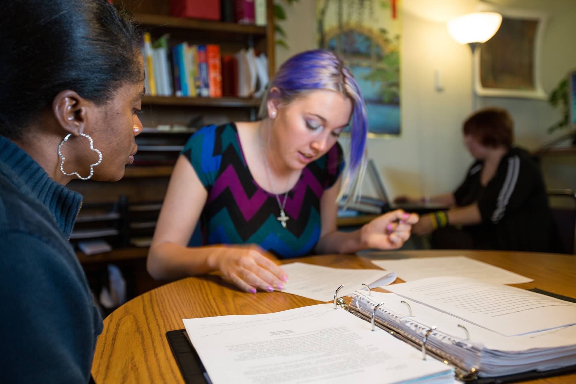 Photo of two students working on writing in an inviting atmosphere.